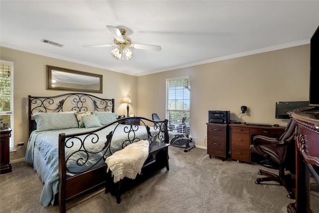 carpeted bedroom featuring ceiling fan and crown molding