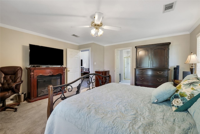 carpeted bedroom with ornamental molding and ceiling fan