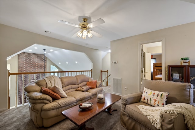 carpeted living room featuring ceiling fan and vaulted ceiling