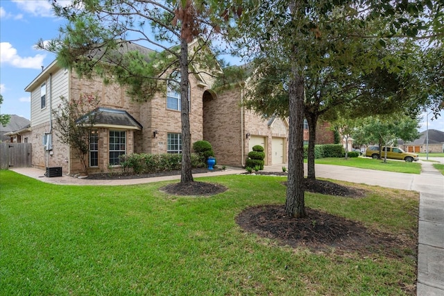 view of front of home with a garage and a front lawn