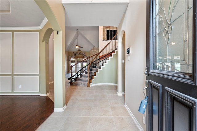 foyer entrance with light hardwood / wood-style flooring and crown molding