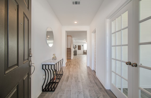 corridor featuring french doors and hardwood / wood-style flooring