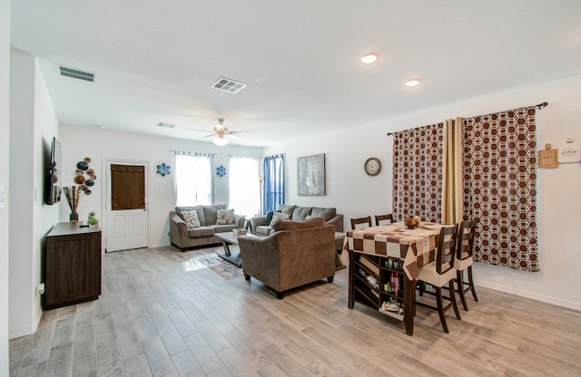 living room with light hardwood / wood-style floors and ceiling fan