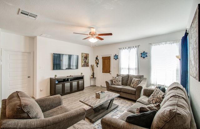 living room featuring light hardwood / wood-style floors and ceiling fan