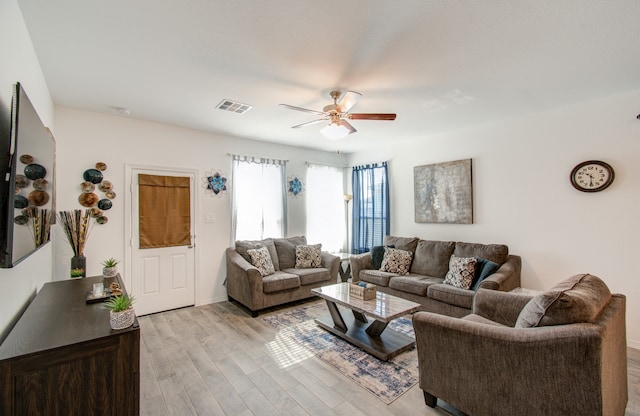 living room with ceiling fan and light hardwood / wood-style flooring