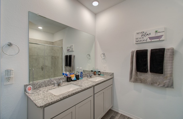 bathroom with hardwood / wood-style floors, a shower with door, and vanity