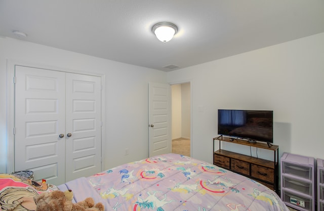 carpeted bedroom featuring a closet