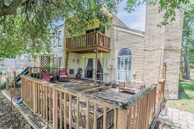 rear view of house with a balcony and a patio