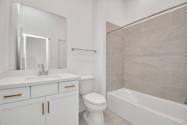 full bathroom featuring tiled shower / bath combo, vanity, and toilet