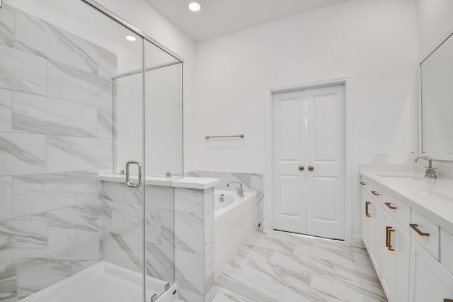 bathroom featuring vanity and shower with separate bathtub