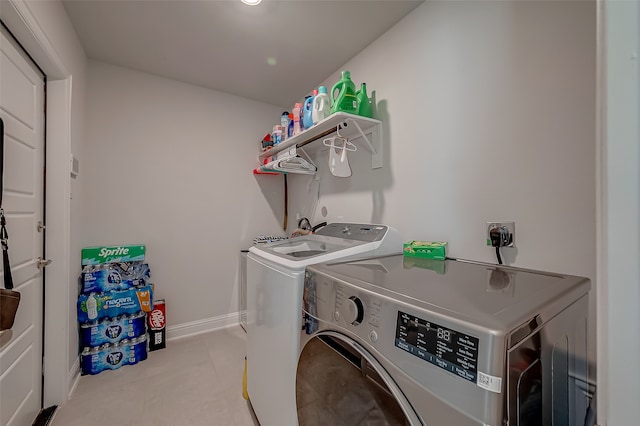 clothes washing area featuring separate washer and dryer