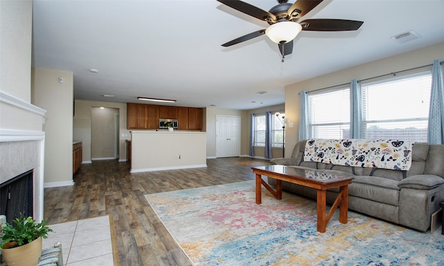 living room featuring ceiling fan and hardwood / wood-style flooring