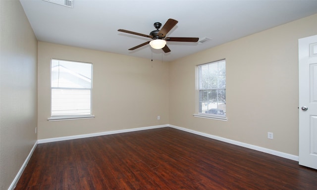 unfurnished room featuring ceiling fan, plenty of natural light, and dark hardwood / wood-style flooring