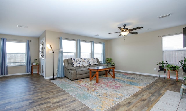 living room with a healthy amount of sunlight, ceiling fan, and hardwood / wood-style flooring