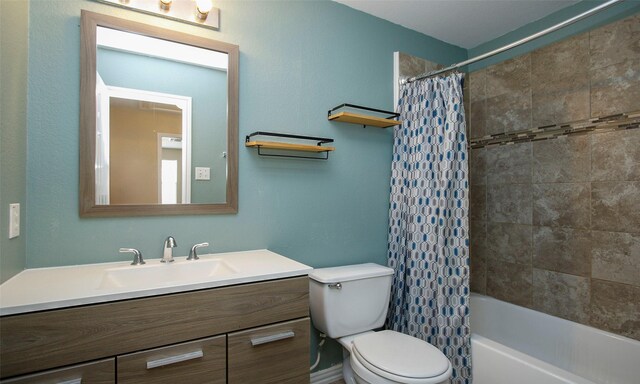 full bathroom with shower / bath combination with curtain, vanity, and toilet