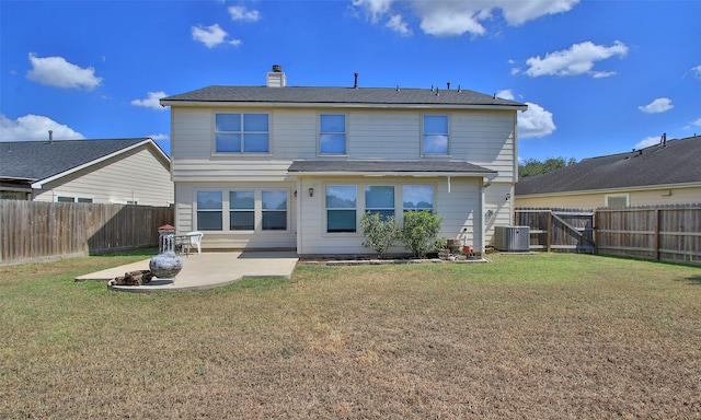 rear view of house with a lawn, a patio, and central air condition unit