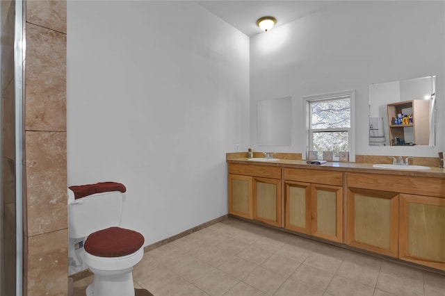 bathroom with vanity, toilet, and tile patterned flooring