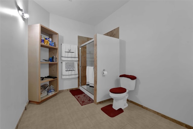 bathroom featuring toilet, tile patterned flooring, and an enclosed shower