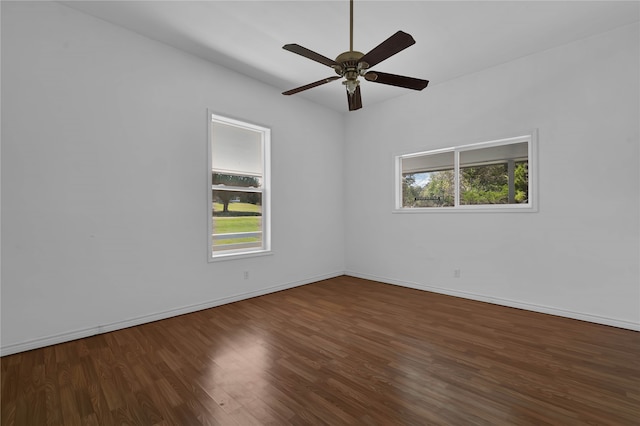 unfurnished room featuring dark wood-type flooring and ceiling fan