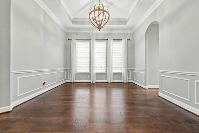 unfurnished room with crown molding, a raised ceiling, plenty of natural light, and dark hardwood / wood-style flooring