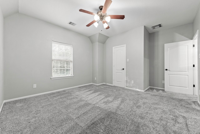 spare room with carpet floors, vaulted ceiling, and ceiling fan