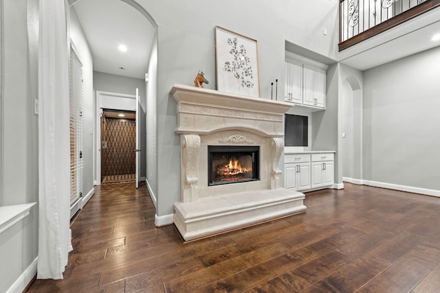 unfurnished living room featuring a fireplace and dark hardwood / wood-style flooring