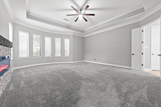 interior space with a raised ceiling, crown molding, ceiling fan, and plenty of natural light