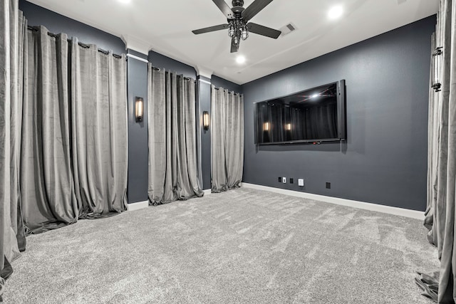 home theater with ceiling fan and carpet flooring