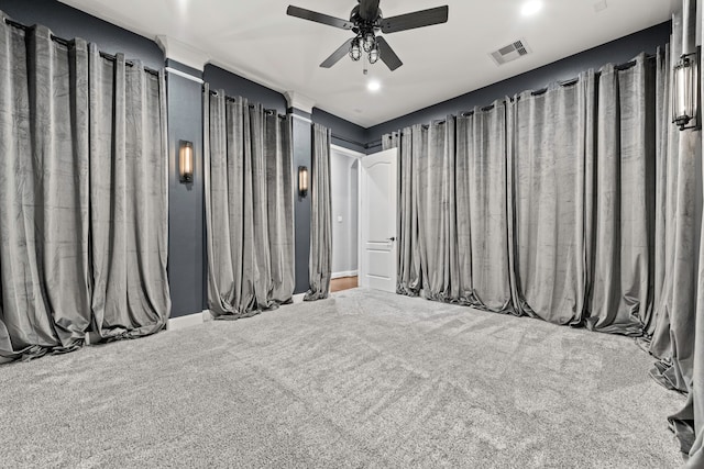 home theater with ceiling fan and carpet