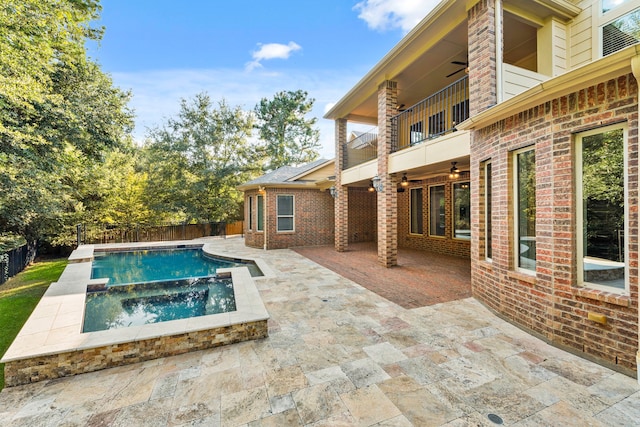 view of pool featuring an in ground hot tub and a patio area