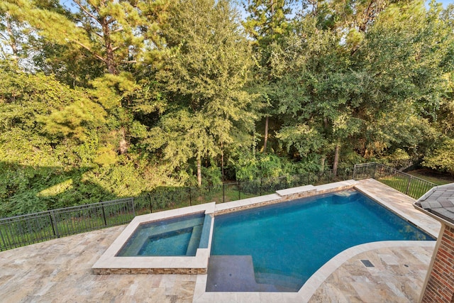 view of swimming pool featuring a patio and an in ground hot tub