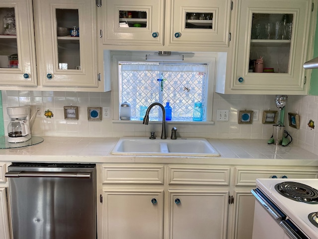 kitchen with stainless steel dishwasher, sink, and tasteful backsplash