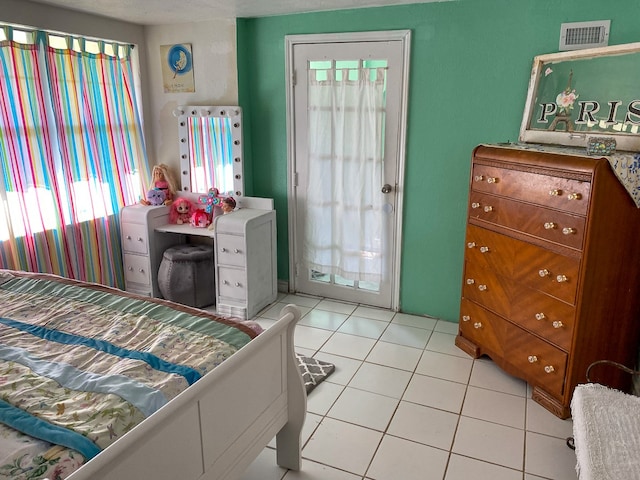 bedroom featuring access to exterior and light tile patterned floors