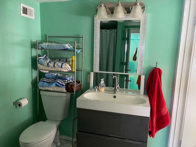 bathroom featuring vanity and toilet