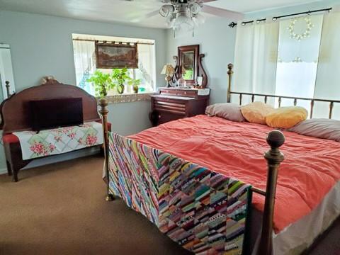 bedroom featuring ceiling fan and carpet floors