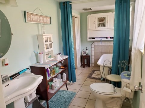 bathroom with tile patterned flooring, toilet, and sink