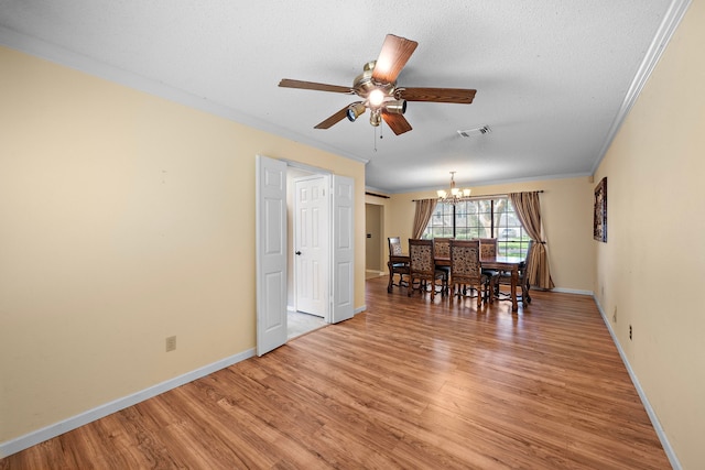 unfurnished dining area with hardwood / wood-style floors, ceiling fan with notable chandelier, crown molding, and a textured ceiling