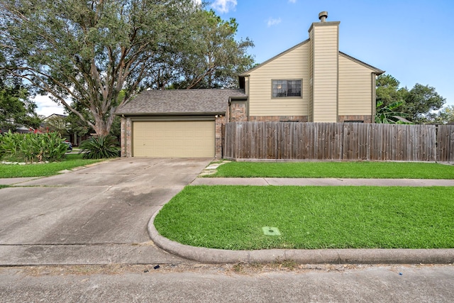 view of front of house with a garage and a front lawn