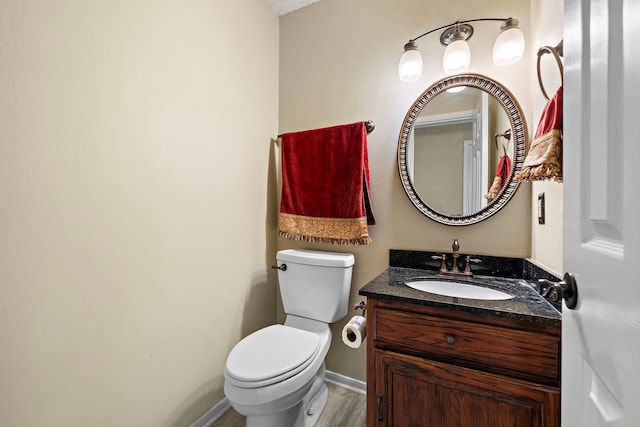 bathroom featuring hardwood / wood-style flooring, vanity, and toilet