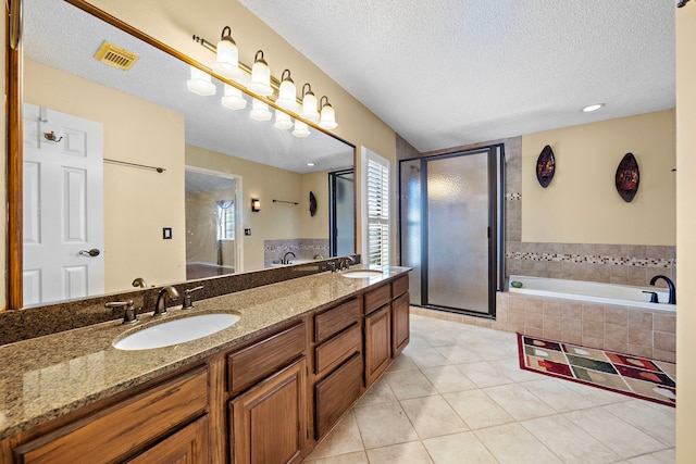 bathroom featuring vanity, a textured ceiling, and tile patterned floors