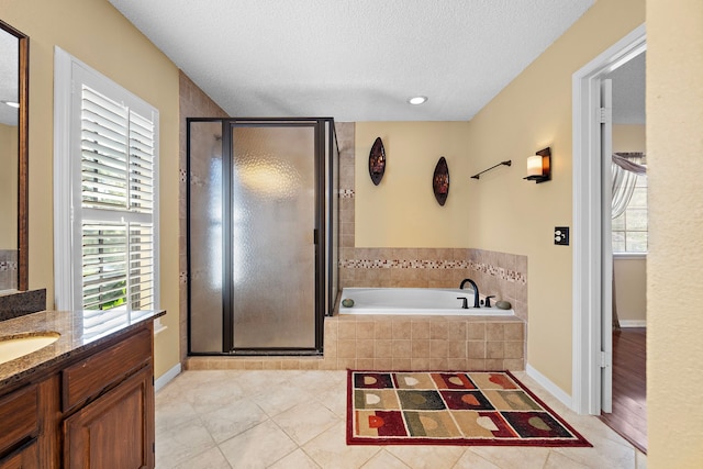 bathroom with separate shower and tub, tile patterned flooring, and a textured ceiling