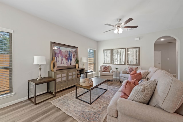 living room featuring ceiling fan and light wood-type flooring