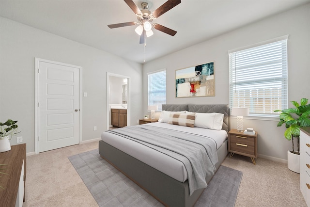 carpeted bedroom featuring connected bathroom and ceiling fan