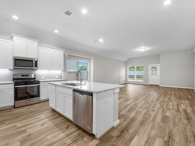 kitchen with appliances with stainless steel finishes, light wood-type flooring, sink, and white cabinetry