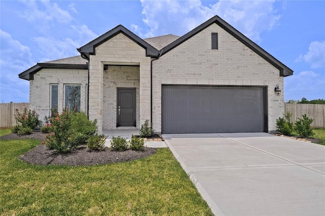 view of front of house with a front yard and a garage