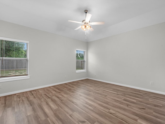 empty room featuring ceiling fan and light wood-type flooring