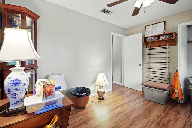 interior space with wood-type flooring and ceiling fan