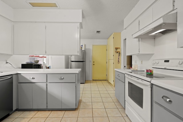 kitchen featuring appliances with stainless steel finishes, a textured ceiling, and light tile patterned floors