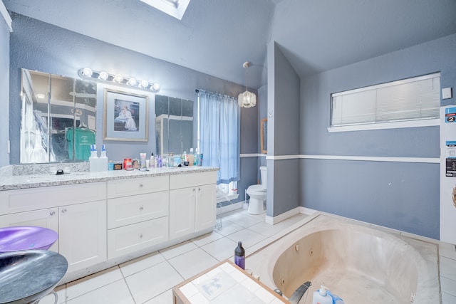 bathroom featuring tile patterned flooring, a tub, lofted ceiling with skylight, vanity, and toilet