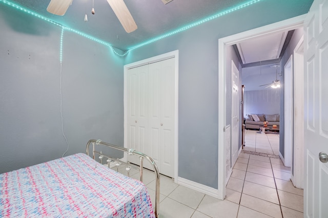 tiled bedroom featuring a closet and ceiling fan